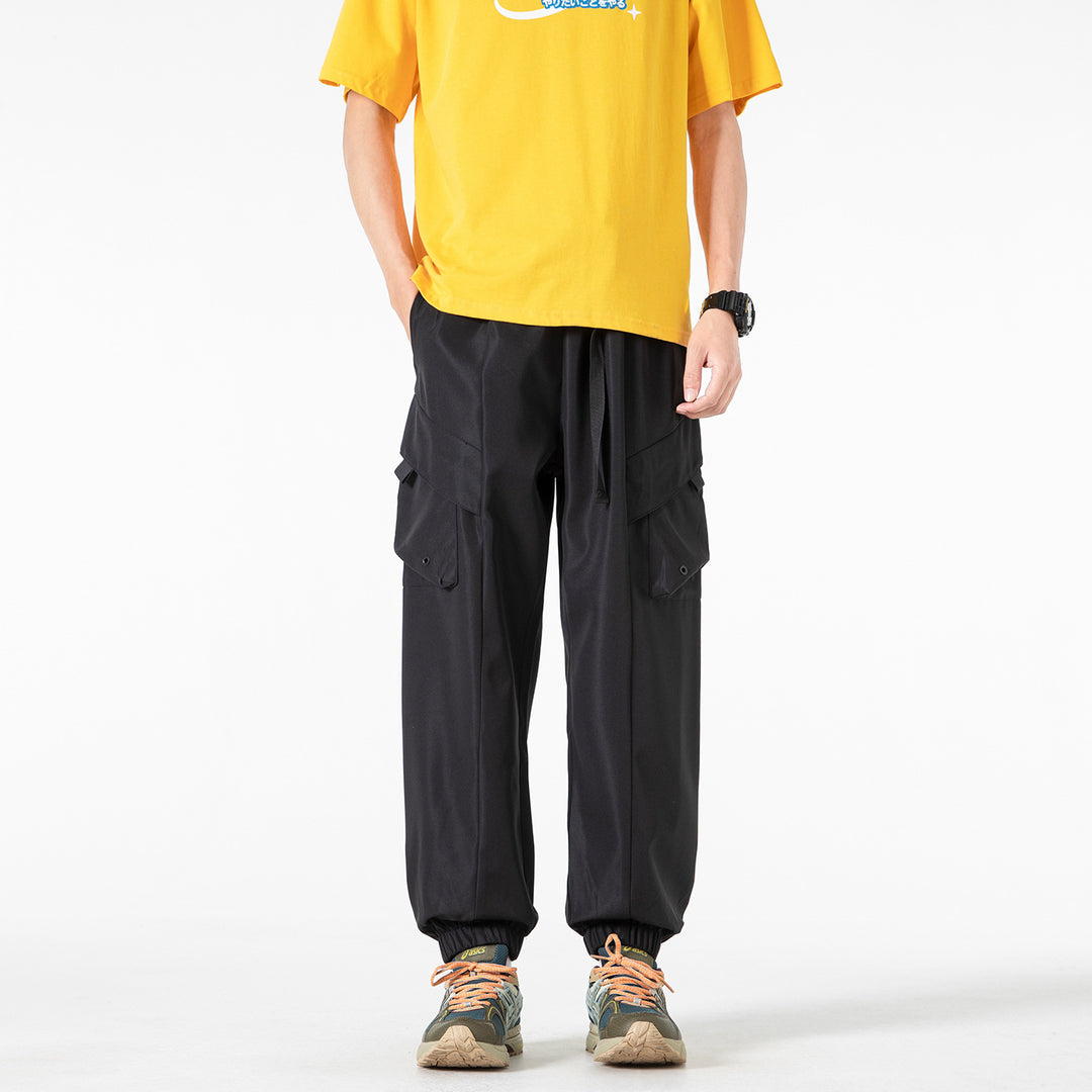 Men's loose cargo jogger pants with elastic drawstring waistband, multiple flap pockets, and ribbed ankles Drune