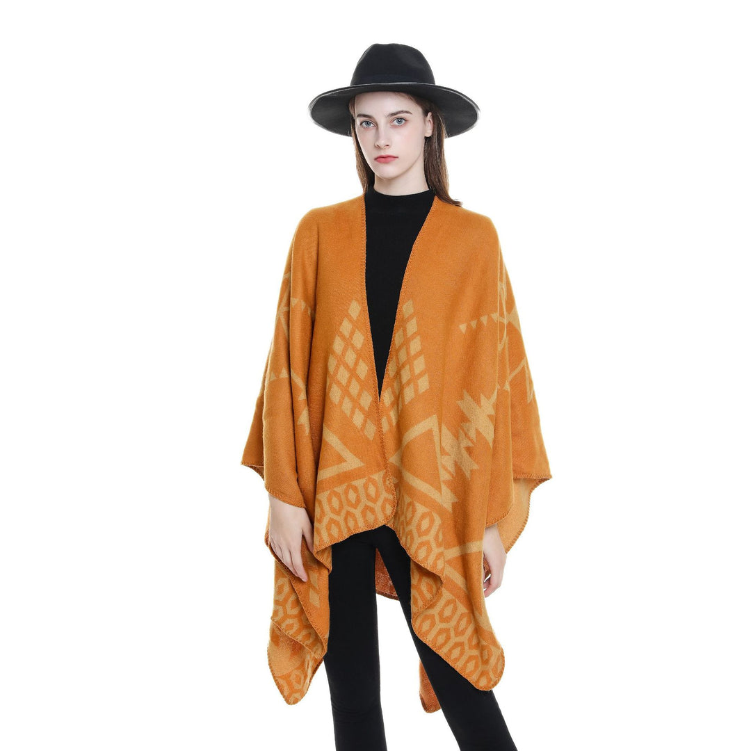 Women's oversized Ruana poncho with cashmere touch, geometric jacquard, and open kimono silhouette.