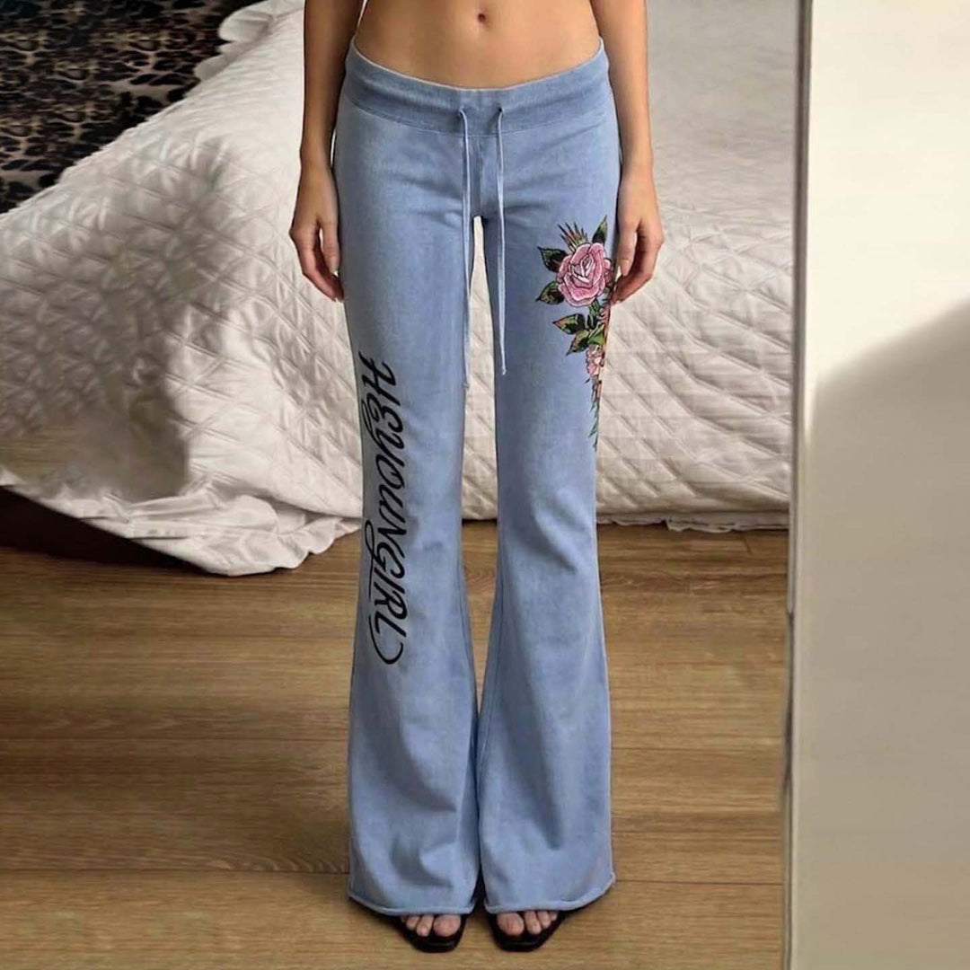 Women's casual jersey sweatpants with drawstring, floral side print, and statement lettering Mune Fashion