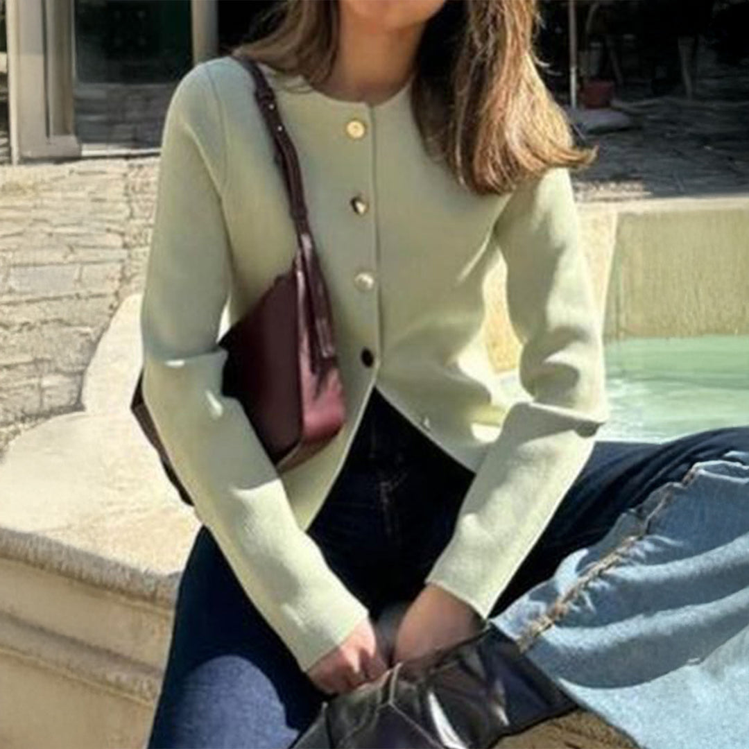 Women’s fitted fine knit cardigan with asymmetrical gold button placket and front slit Mune Fashion
