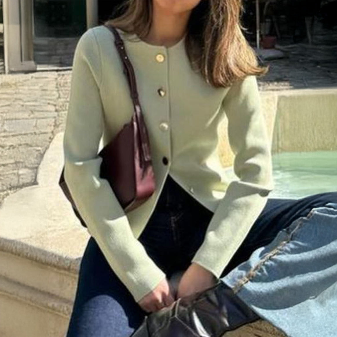 Women’s fitted fine knit cardigan with asymmetrical gold button placket and front slit Mune Fashion