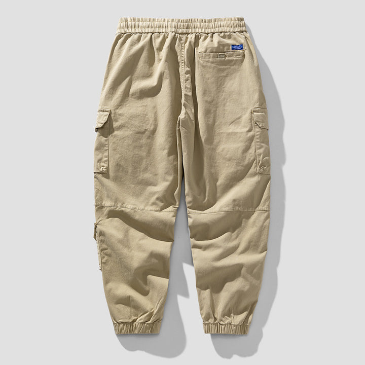 Herren Leichte Canvas-Cargohose im Joggerstil mit elastischem Bund, segmentierten Kniepaneelen und verdeckten Klappentaschen Mune Fashion