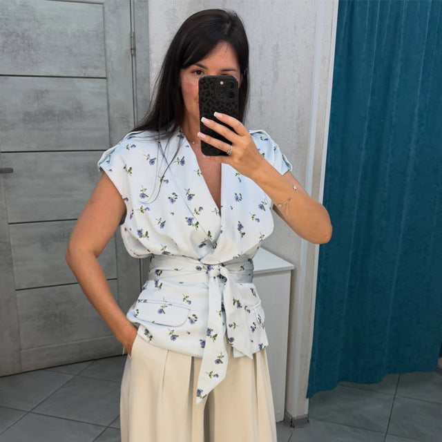 Women's sleeveless wrap blouse with fitted tie belt and patch pockets Mune Fashion