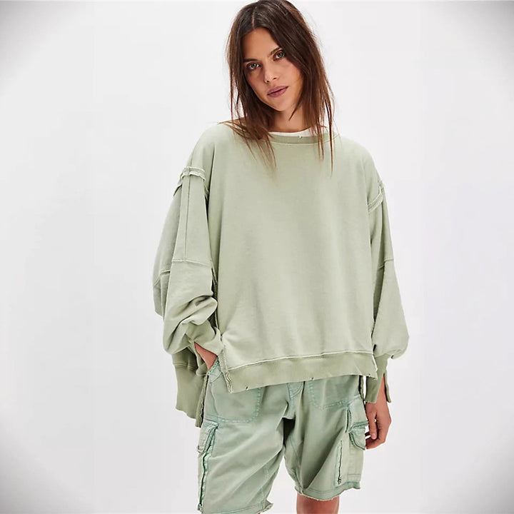 Women's oversized sweatshirt with balloon sleeves, open seam stitches, and side slits Mune Fashion