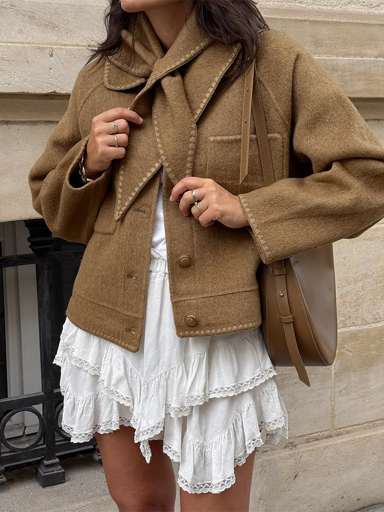 Women's short jacket made of wool blend with a suggested shawl collar, decorative seams, and boxy cropped cut Mune Fashion