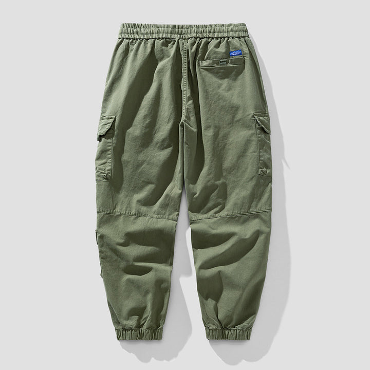 Herren Leichte Canvas-Cargohose im Joggerstil mit elastischem Bund, segmentierten Kniepaneelen und verdeckten Klappentaschen Mune Fashion