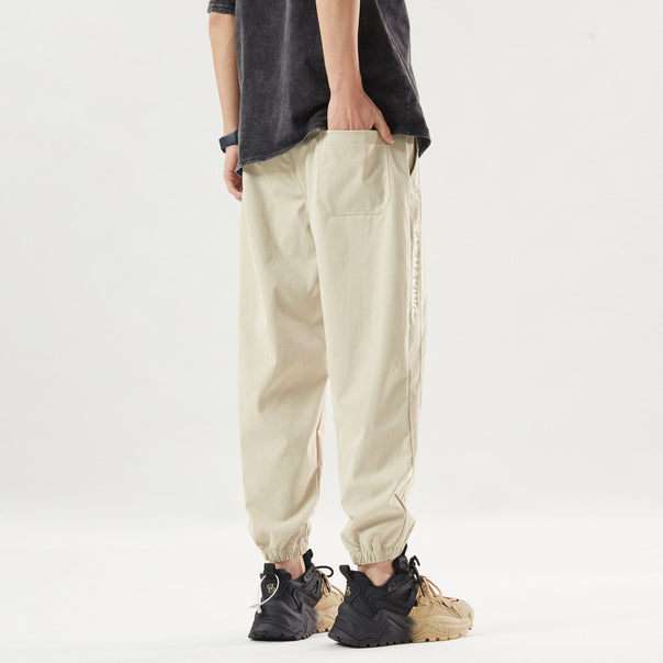 Men's sporty jogging pants with elastic waistband and zippered pockets Mune Fashion