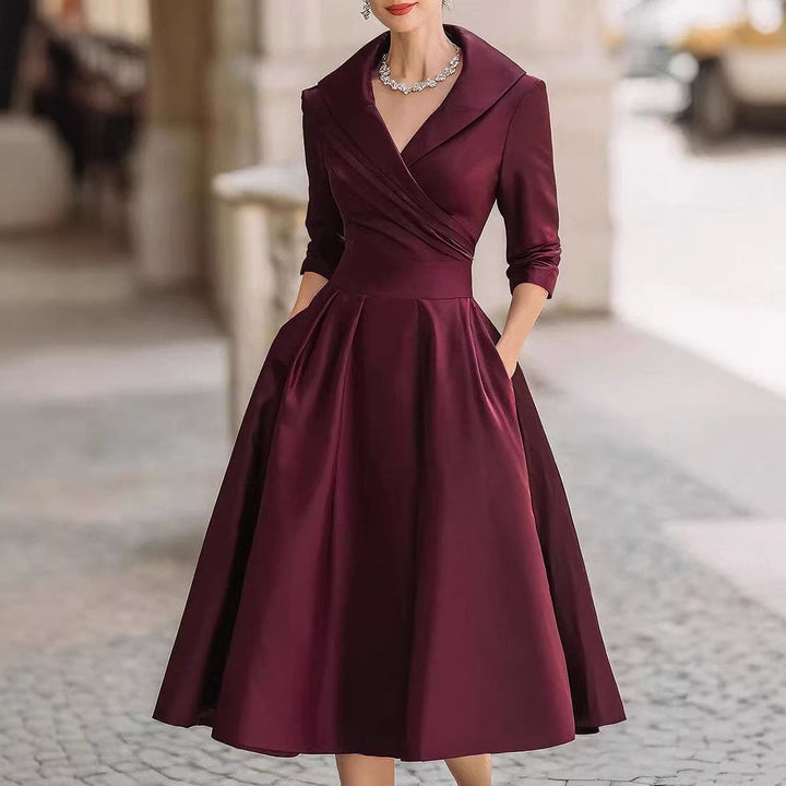 Women's elegant midi dress with wrap top, three-quarter sleeves, and side pockets Mune Fashion