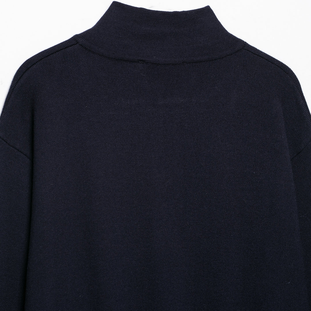 Women's cropped fine-knit cardigan with standing collar, full-length zipper, and fitted ribbed section.