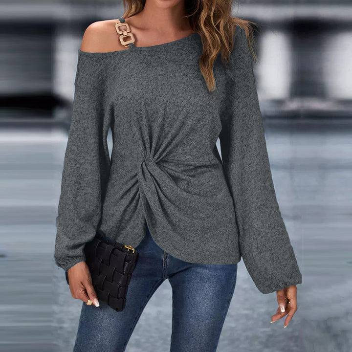 Women’s asymmetrical off-shoulder knit sweater with decorative chain strap and twisted knot front Mune Fashion