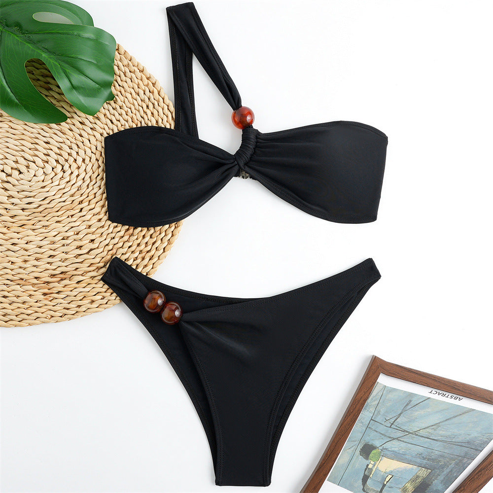 Women's bikini set with asymmetric halter neck and decorative pants buttons Mune Fashion