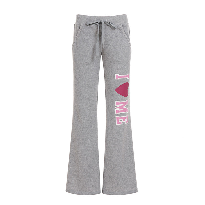 Women's soft flared jogging pants with drawstring, side pockets, and eye-catching Love print Mune Fashion