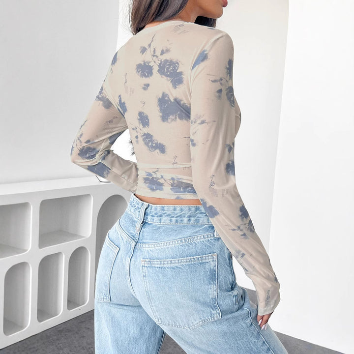 Women's form-fitting tailored crop mesh top with round neck, extended sleeves, thumb holes, and subtle tie-dye pattern Mune Fashion