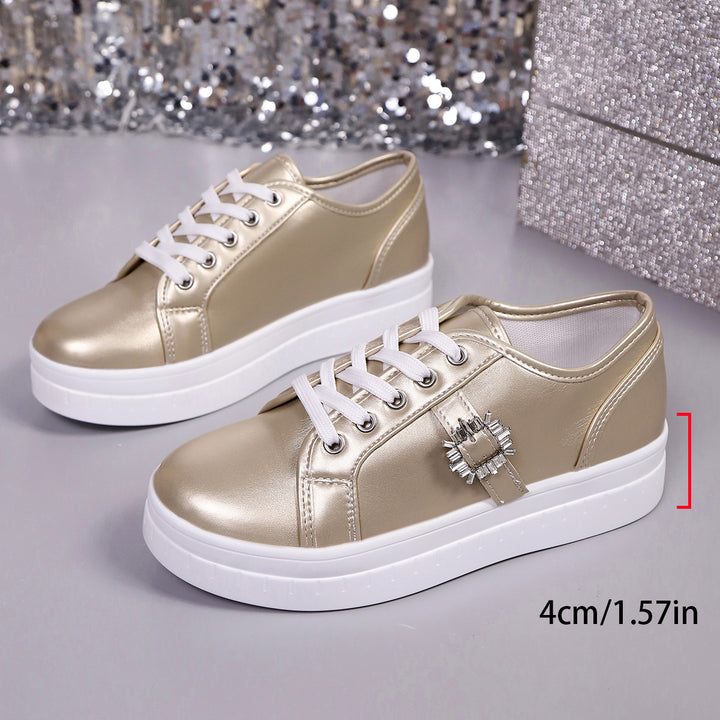 Ladies' platform sneaker with metallic upper material, decorative rhinestone buckle, and padded comfort sole Mune Fashion