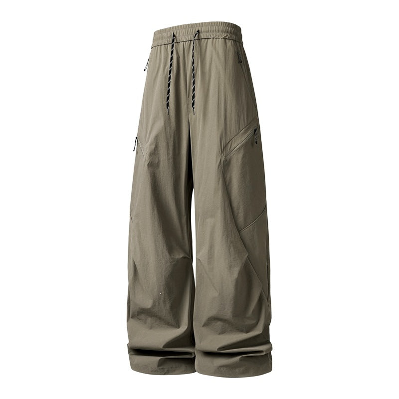 Men's Oversize Utility Cargo Pants made of lightweight nylon with elastic drawstring waistband, side zipper pockets & wide balloon silhouette Mune Fashion
