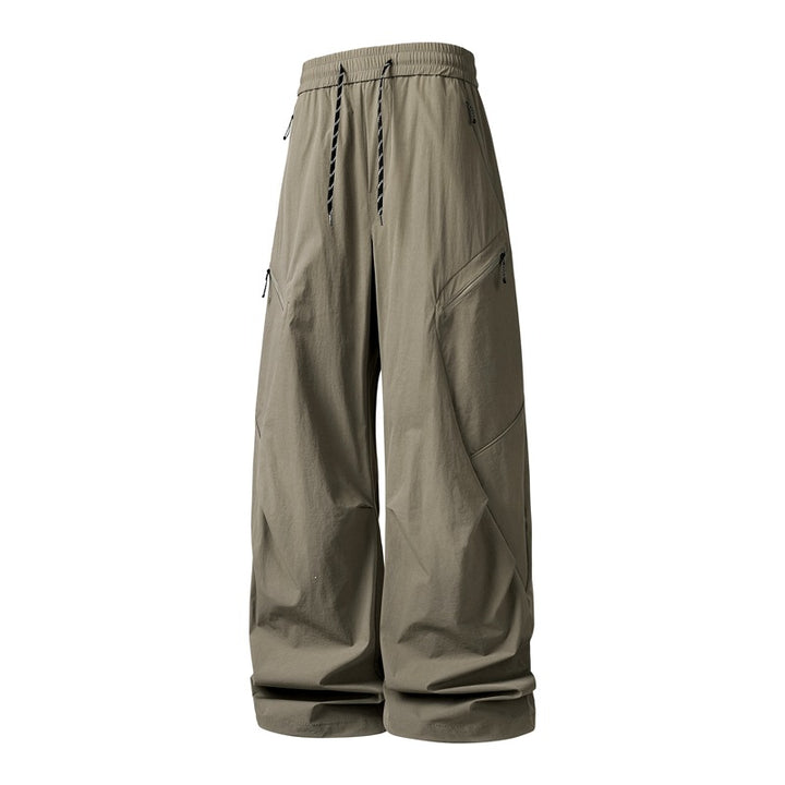 Men's Oversize Utility Cargo Pants made of lightweight nylon with elastic drawstring waistband, side zipper pockets & wide balloon silhouette Mune Fashion