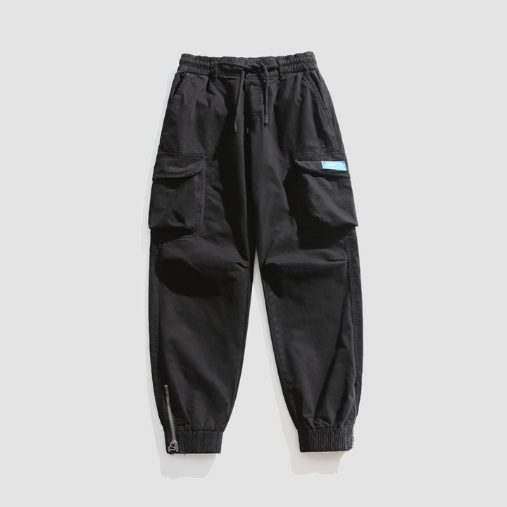 Herren Konisch geschnittene Utility-Cargo-Jogginghose mit Tunnelzugbund, Klapptaschen und Knöchelreißverschlüssen Mune Fashion