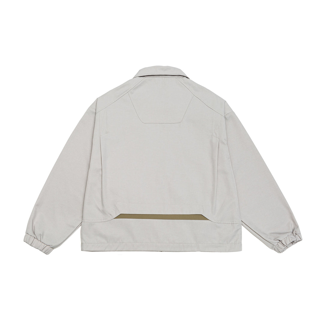 Unisex short jacket in boxy cut with shirt collar, visible metal zipper and utility patch pockets Mune Fashion