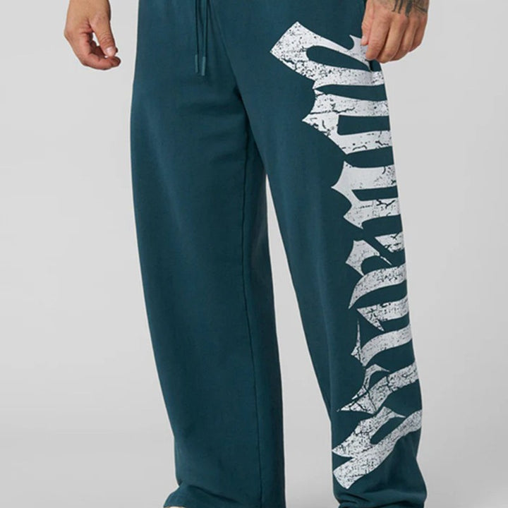 Men's wide sweatpants made of brushed fleece with side vintage print and drawstring waistband Mune Fashion