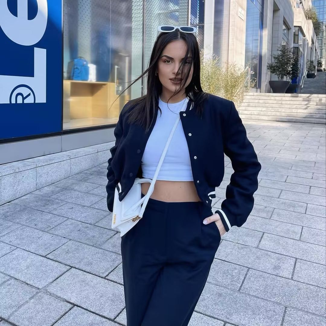 Women nan short college bomber jacket with snap button closure, ribbed stripe waistband and side pockets Mune Fashion