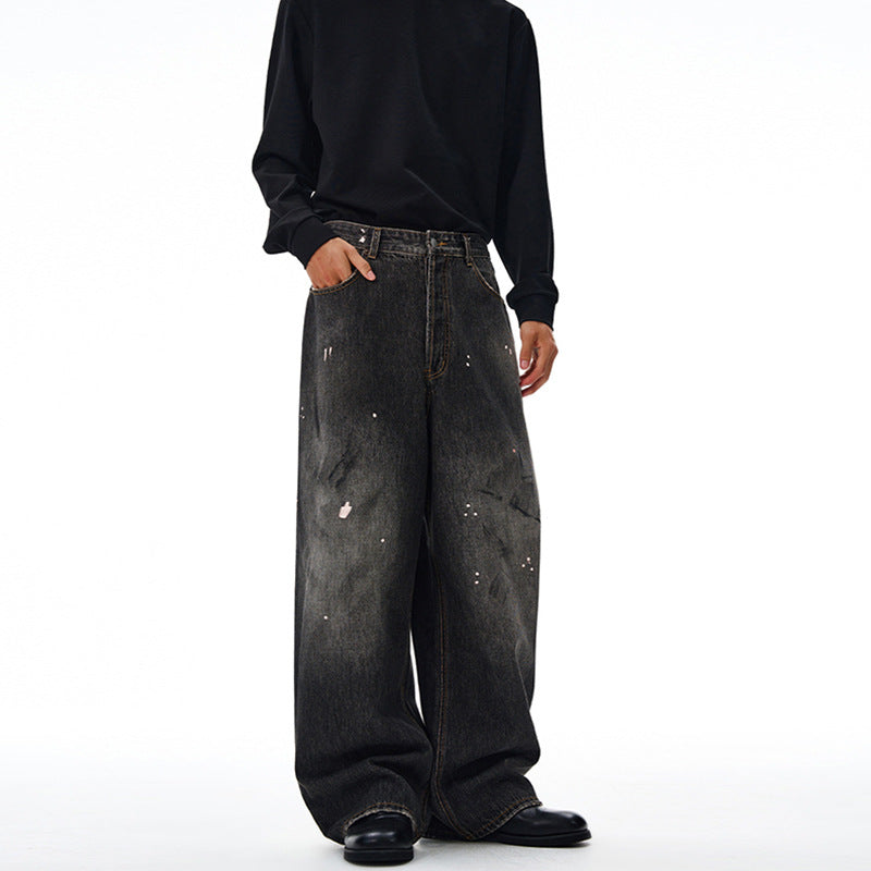 Men's loosely cut denim pants in floor-length baggy style with subtle paint splatter look Mune Fashion