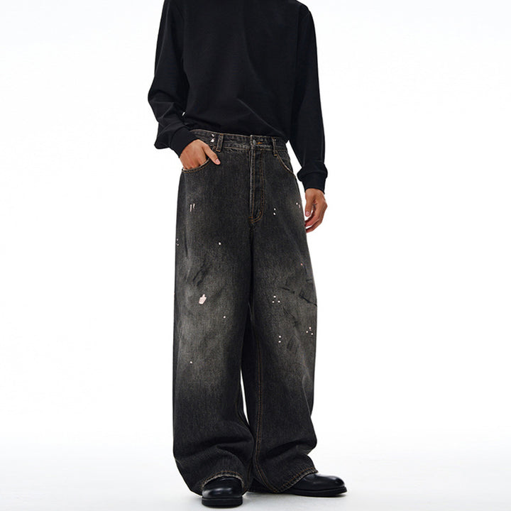 Men's loosely cut denim pants in floor-length baggy style with subtle paint splatter look Mune Fashion