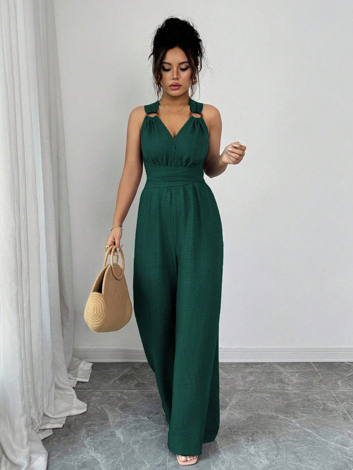 Women’s jumpsuit with wide leg, tailored wrap belt and eyelet straps Mune Fashion
