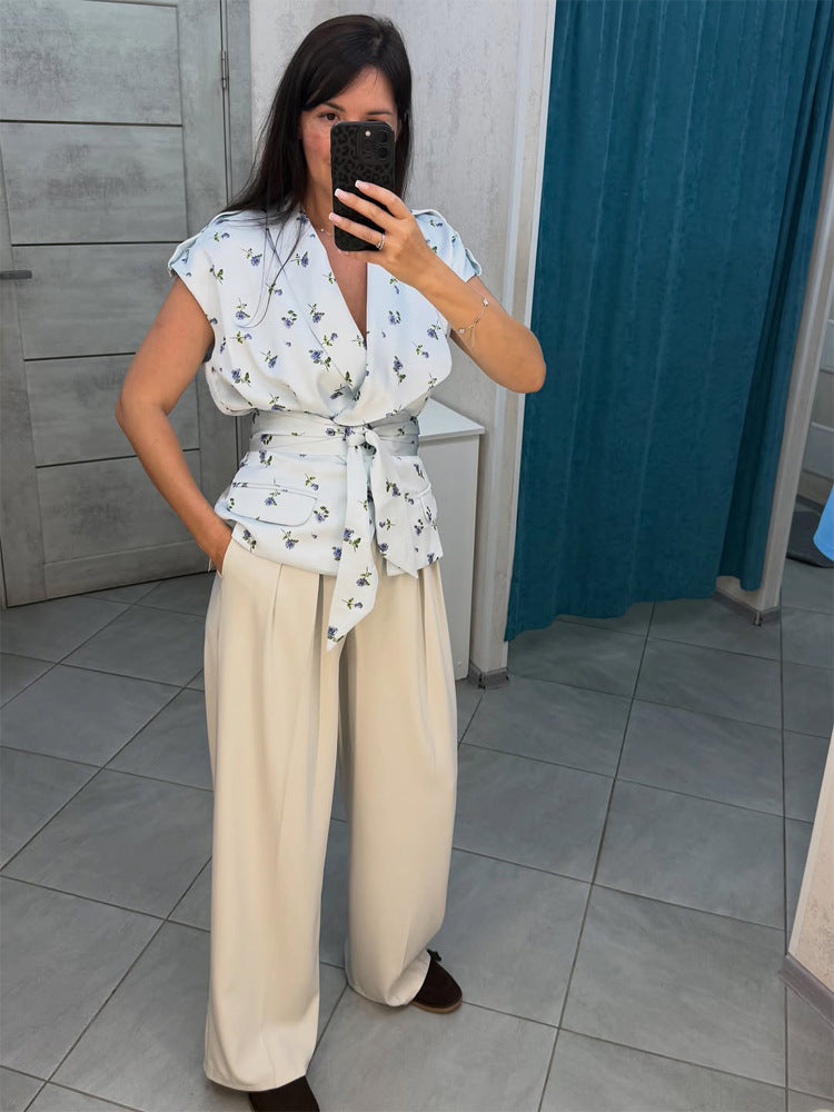 Women's sleeveless wrap blouse with fitted tie belt and patch pockets Mune Fashion