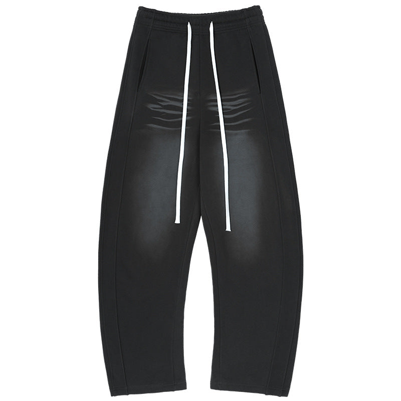 Men's baggy sweatpants with low crotch, contrasting decorative seams, and extra long drawstrings.