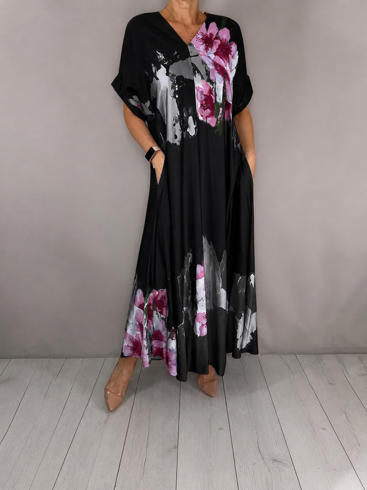 Women's maxi dress with a flowing fall, V-neck, side pockets, and floral watercolor look Mune Fashion