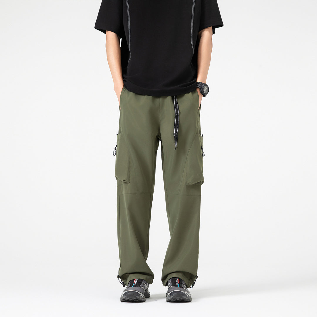 Men's wide cargo pants in baggy style with drawstring waistband, large flap pockets, and adjustable leg openings Drune