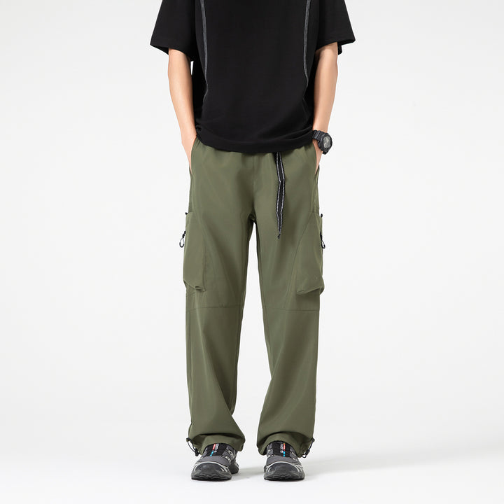 Men's wide cargo pants in baggy style with drawstring waistband, large flap pockets, and adjustable leg openings Drune