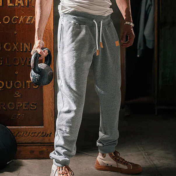 Men's tapered leisure pants made of sweat fabric with elastic waistband, drawstring, and ribbed cuffs Mune Fashion