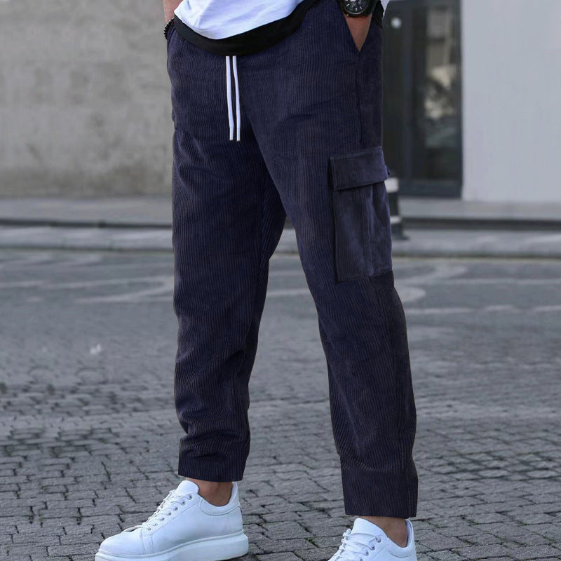 Men's corduroy jogger-style pants with elastic drawstring waistband, flap cargo pockets, and tapered leg Mune Fashion