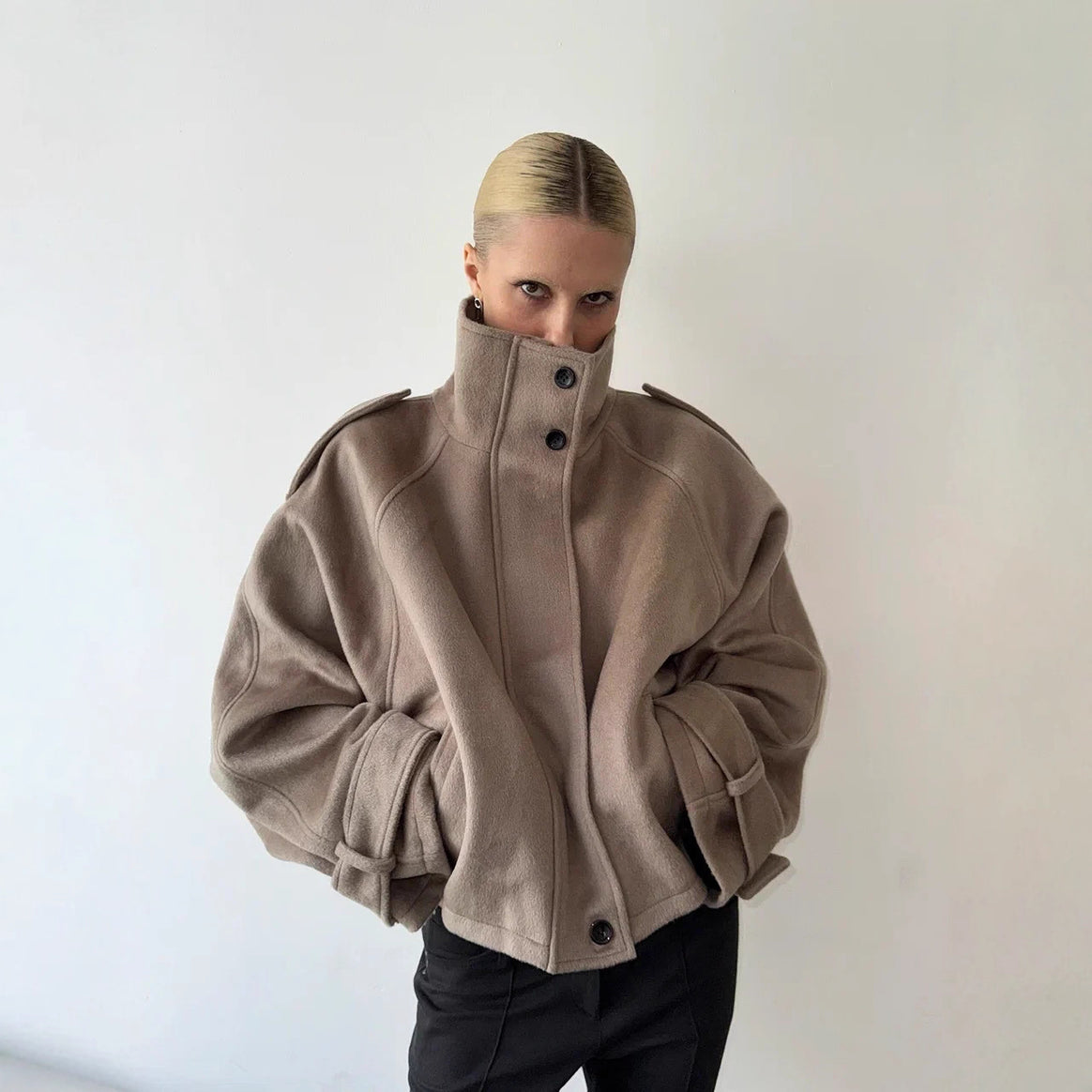 Ladies short cut oversized wool jacket with high stand-up collar, shoulder flaps and adjustable sleeve straps Mune Fashion