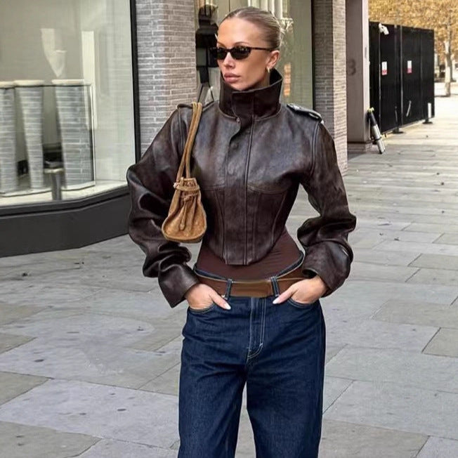 Women's short jacket made of faux leather with a high stand-up collar, shoulder flaps, and tailored silhouette Mune Fashion