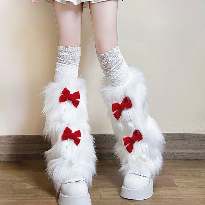 Ladies cozy boot cuffs made of faux fur with bow appliqué and pompons Mune Fashion