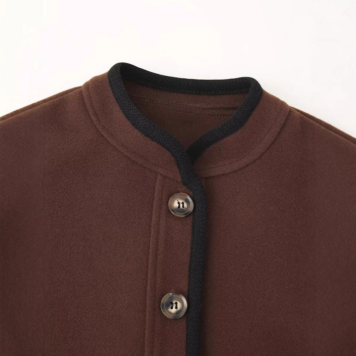 Women's casual short jacket with round neckline, contrast piping, and welt pockets Mune Fashion