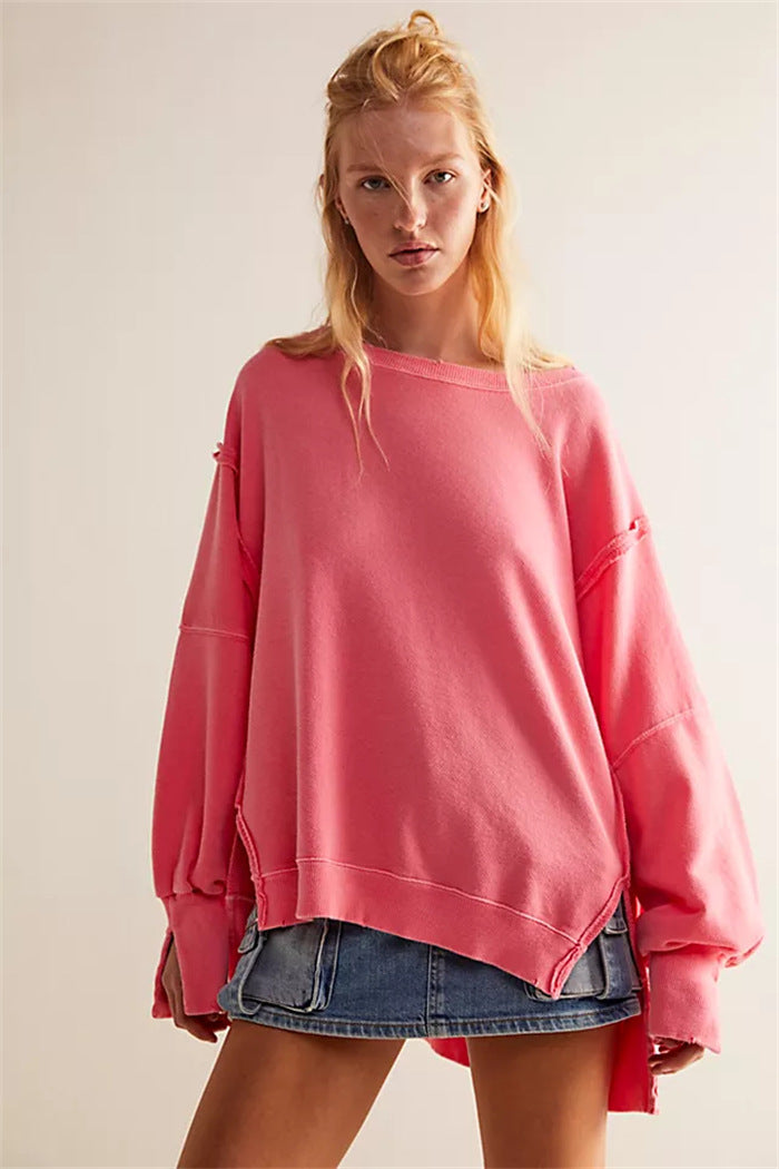 Women's oversized sweatshirt with balloon sleeves, open seam stitches, and side slits Mune Fashion