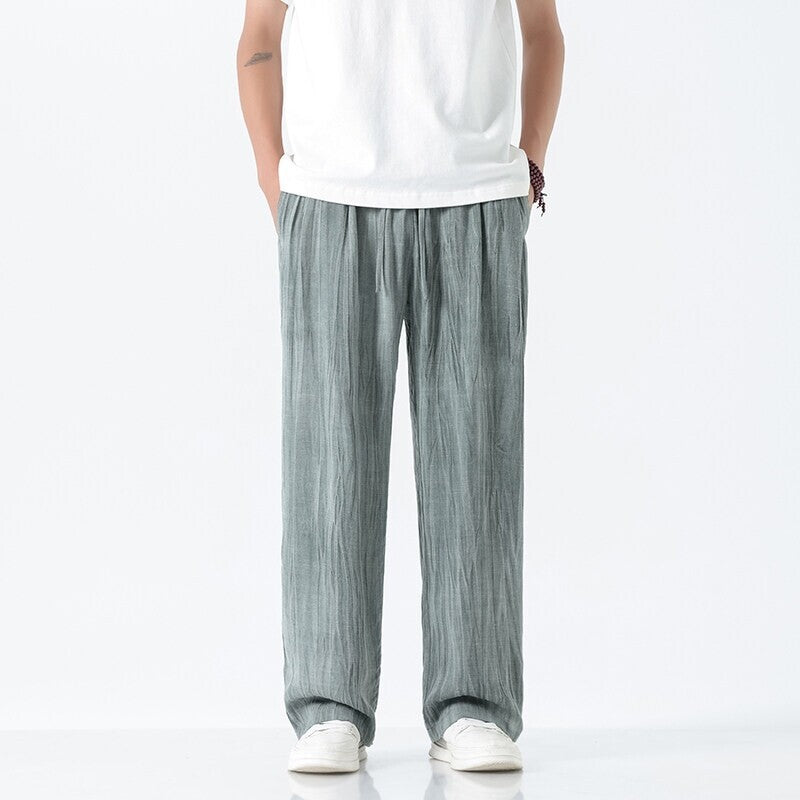 Men's loose linen trousers with adjustable drawstring waistband, casual pleat look, and side pockets Mune Fashion