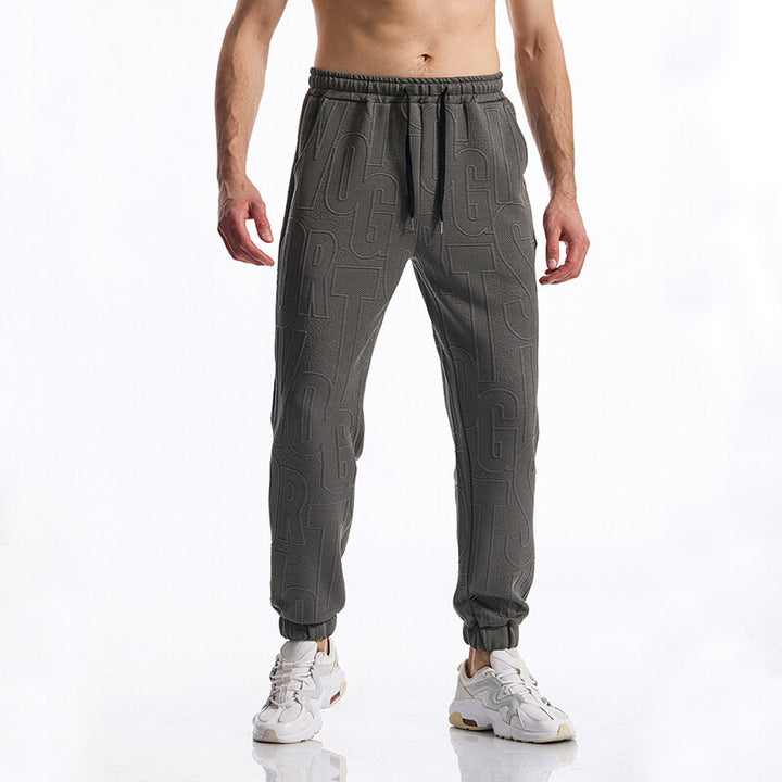 Men's jogging pants with elastic waistband, drawstring, and embossed all-over logo relief Mune Fashion