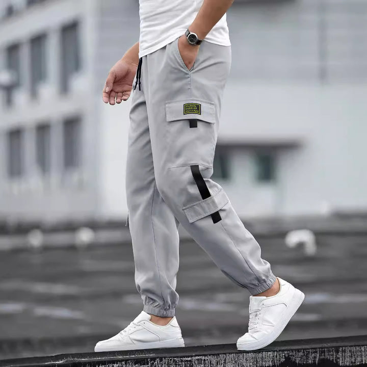 Men's fashionable cargo jogger pants with elastic waistband, drawstring, and multiple security and flap pockets Mune Fashion