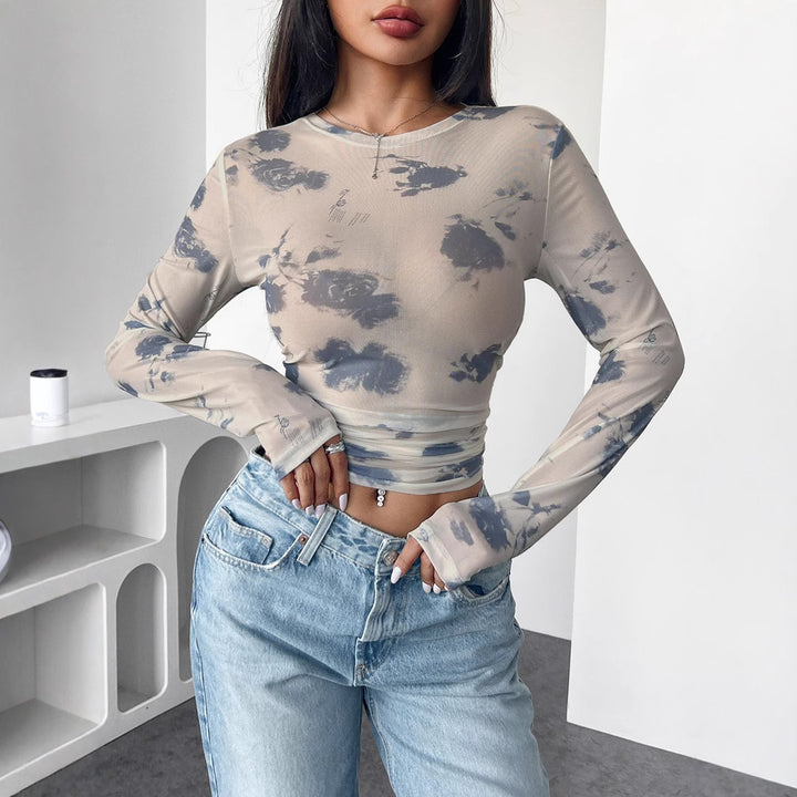 Women's form-fitting tailored crop mesh top with round neck, extended sleeves, thumb holes, and subtle tie-dye pattern Mune Fashion