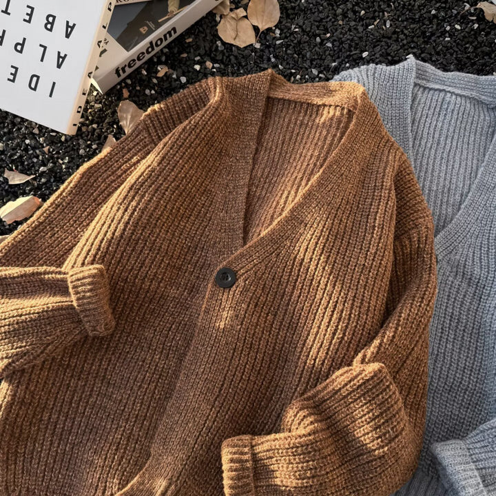 Unisex chunky knit cardigan in oversized cut with deep V-neck and distinctive button placket Mune Fashion
