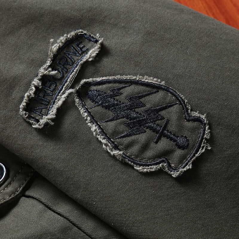 Men's canvas field jacket in military utility style with stand-up collar, shoulder patches, and multi-functional pockets Mune Fashion
