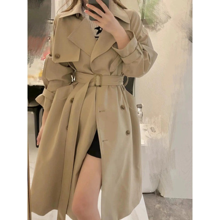 Women's elegant midi trench coat with oversized shoulder flap, gathered sleeves, and waist-defining tie belt Mune Fashion