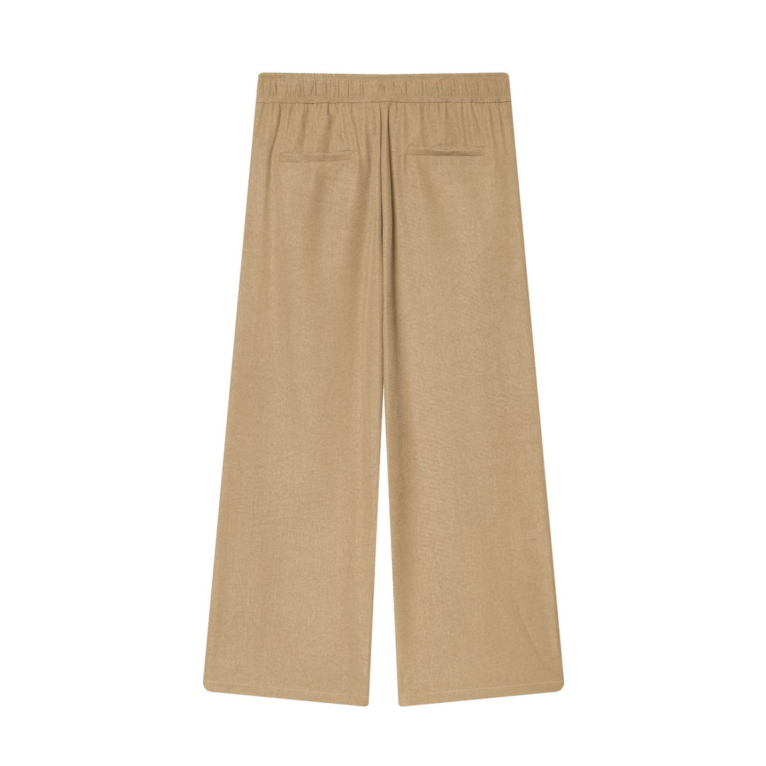 Women's loose high-waist pants with drawstring, decorative dividing seams, and flared leg Mune Fashion