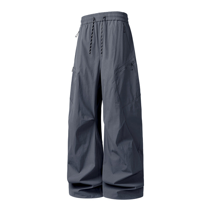 Men's Oversize Utility Cargo Pants made of lightweight nylon with elastic drawstring waistband, side zipper pockets & wide balloon silhouette Mune Fashion