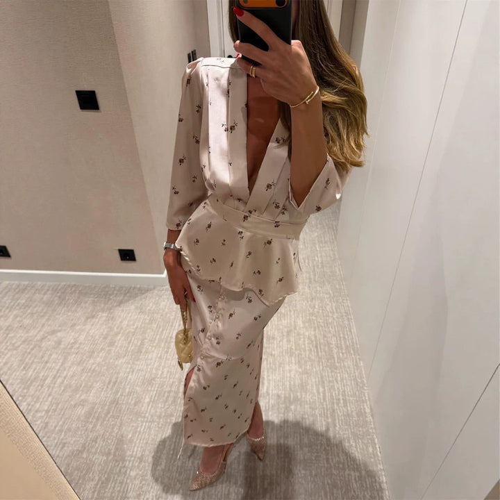 Women's satin two-piece set with tailored peplum top, deep V-neckline and button-up midi skirt Mune Fashion