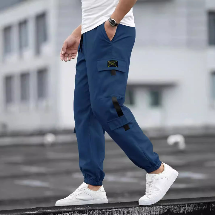 Men's fashionable cargo jogger pants with elastic waistband, drawstring, and multiple security and flap pockets Mune Fashion